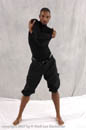Young male dancer in taunt pose and black costume