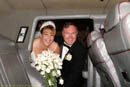 Bride and groom entering limo