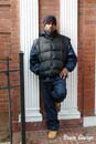 Young African American poet against a brick wall